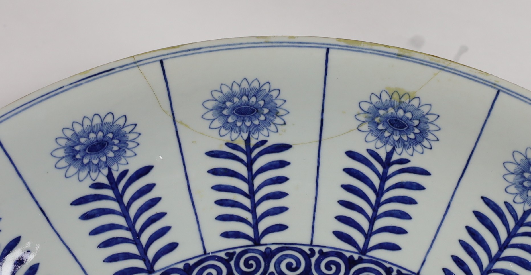 A pair of massive Chinese blue and white Aster pattern dishes, Kangxi mark but Republic period, 54.5cm diameter, one with a small section broken and restuck